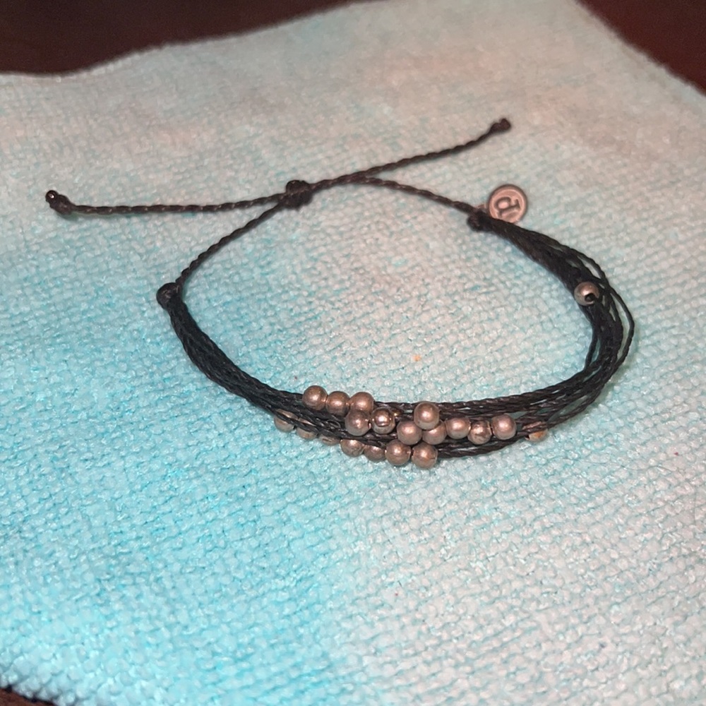 Pure Vida adjustable bracelet with metal beads.